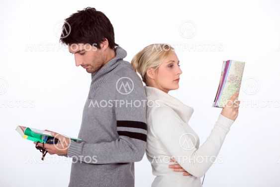 A couple looking at their guide and their map.