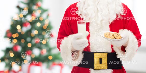 close up of santa claus with milk and cookies