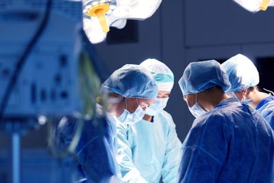 group of surgeons in operating room at hospital