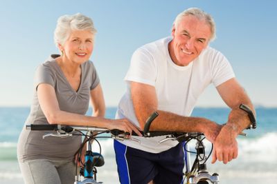 Retired couple with their bikes on the beach