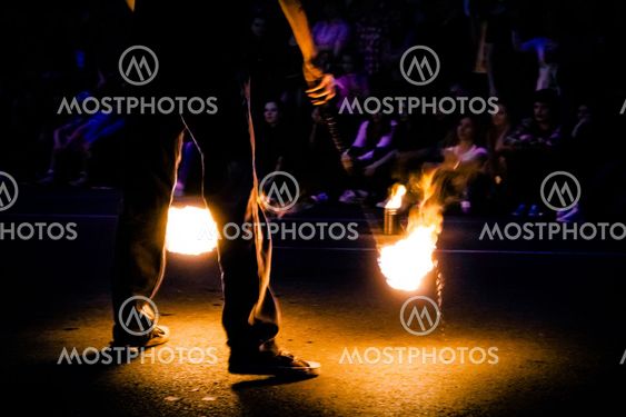 Fire show artist with two burning torches