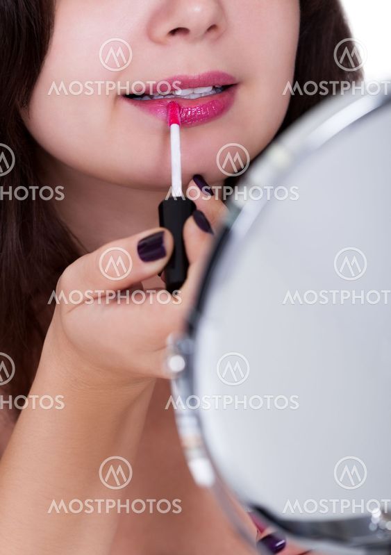 Woman applying lipstick