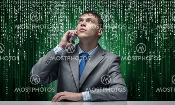 Young man talking on phone and looking upward.