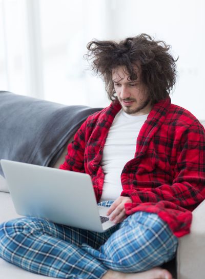 man freelancer in bathrobe working from home