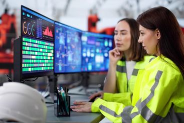 Female engineer monitors automated manufacturing system