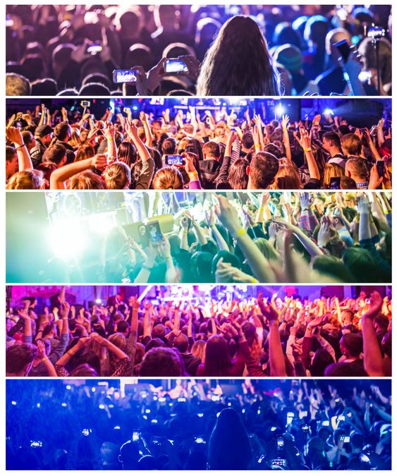 Rock concert, silhouettes of happy people raising up hands