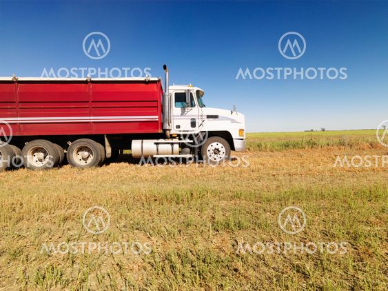 Semi truck in field.