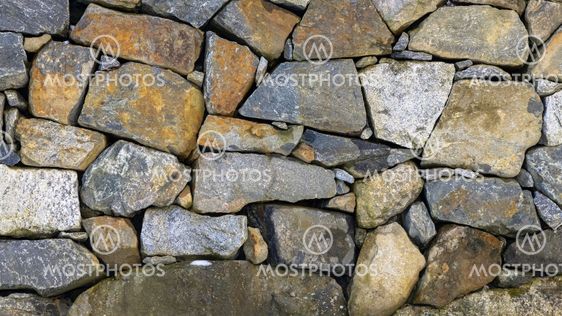Granite stone wall with colorful stones