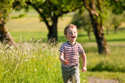 Boy running down a dirtpath