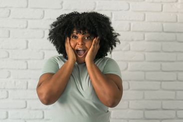 African American woman expressing pure joy with an...