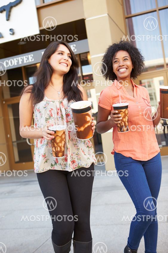 Two Female Friends Standing Outside Cinema Together