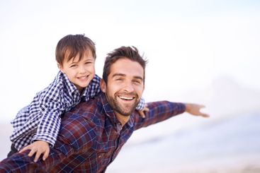 Portrait, dad and son on beach with airplane game, smile...
