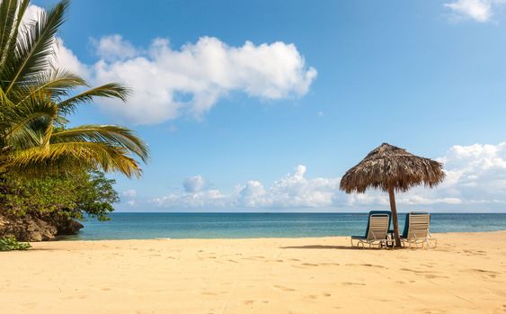 Sunbed and umbrella on a tropical beach