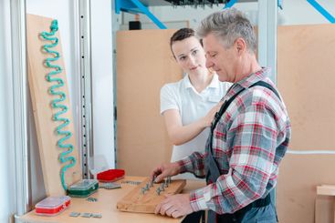Worker in occupational therapy re-learning to lay bricks