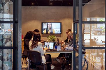 Multiracial business team discussing through virtual...