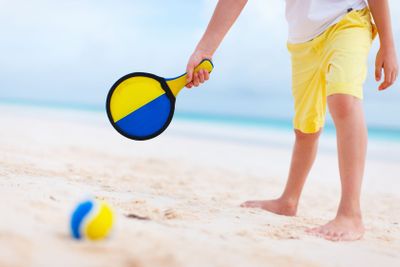Boy playing beach tennis