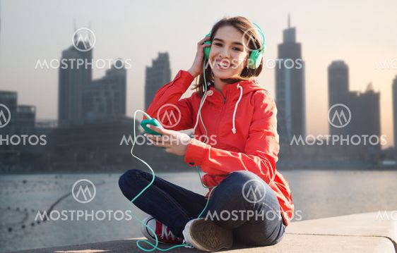 happy young woman with smartphone and headphones