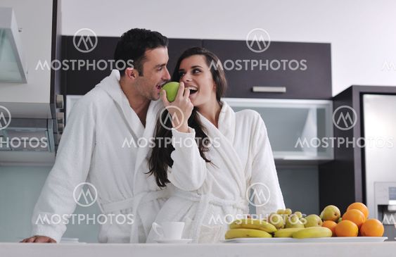 young couple have fun in modern kitchen