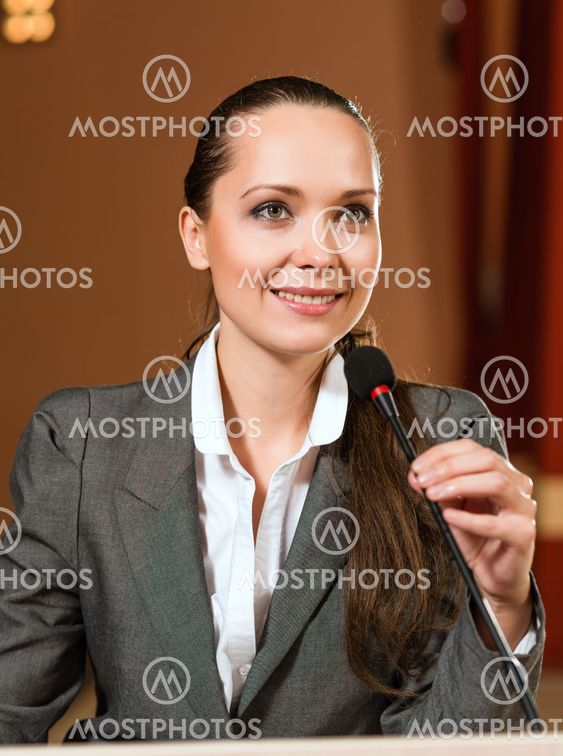 Portrait of a business woman with microphone