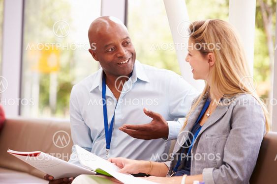 Two College Tutors Having Discussion Together