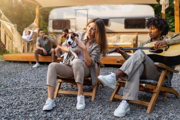 Young black guy playing guitar and singing, Caucasian...