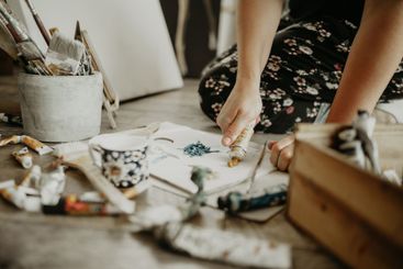 Paint, paper and creative person in studio, art and...