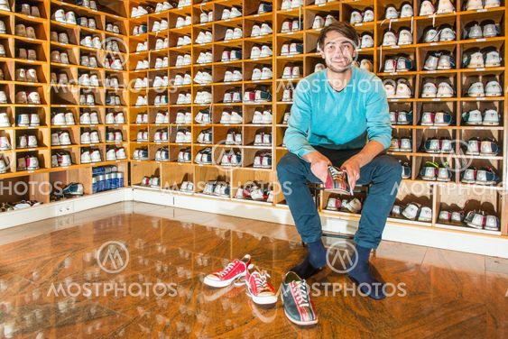 Man in a changing room trying on bowling shoes