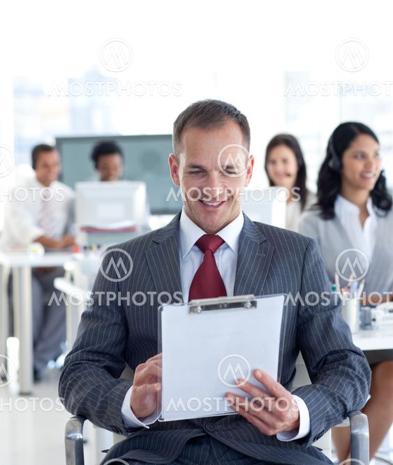 Male manager writing notes in a call center