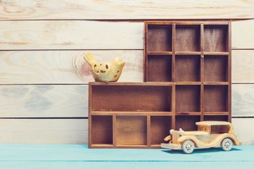 Cozy pastel wooden home decor objects on blue background
