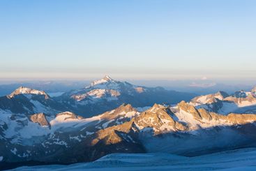 mountain peaks in morning dawn light, panoramic natural...