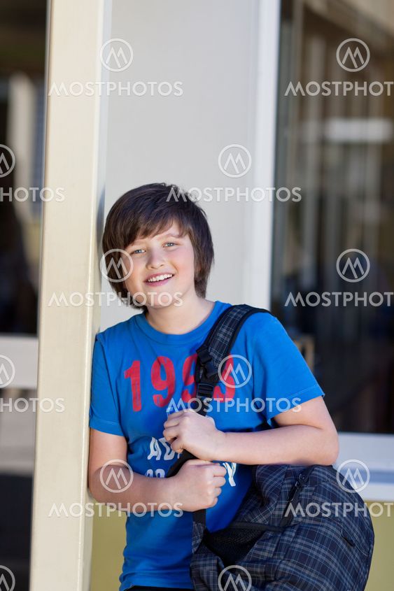 Happy young boy going to school