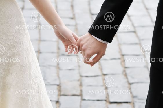 Bride and groom holding hands