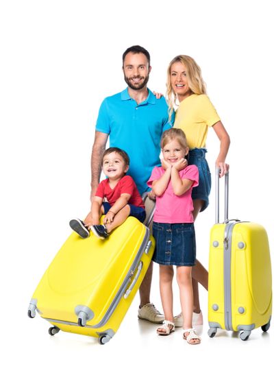 family with yellow travel bags isolated on white