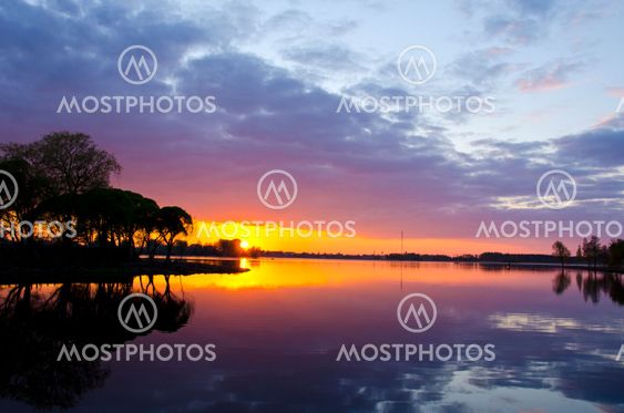summer lake sunset. Boats sky reflections water