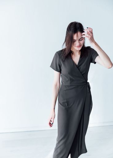 Beautiful fashionable brunette woman in green summer...