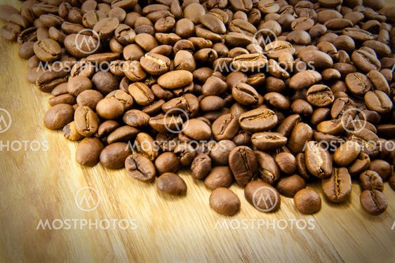Coffee beans on vintage wooden board
