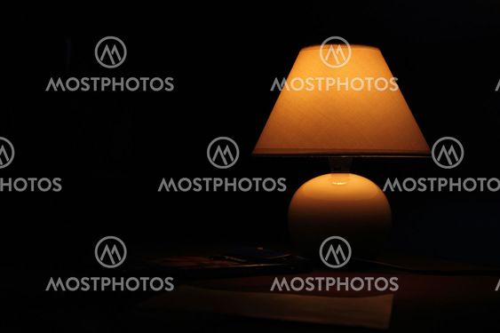 Ancient lamp on table in the dark