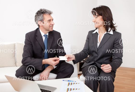 Two business people exchanging visiting card