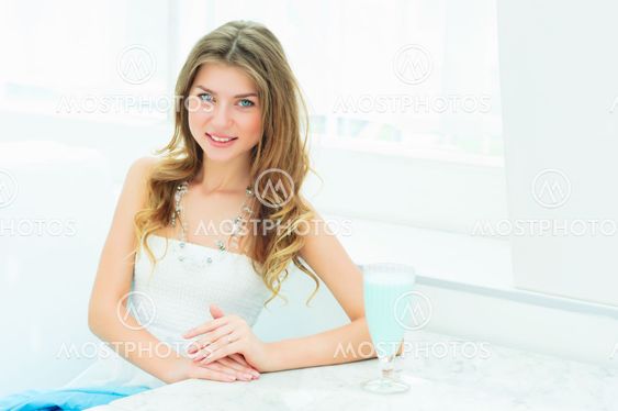 Portrait of a cute woman in a city cafe