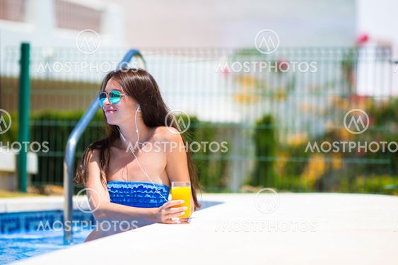 Young beautiful woman listening music with headphones...