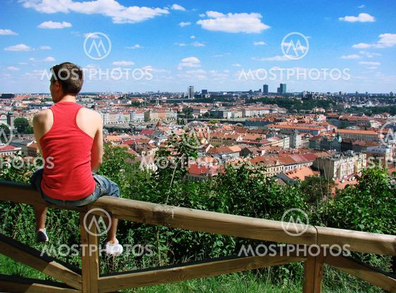 A guy sitting on a fence