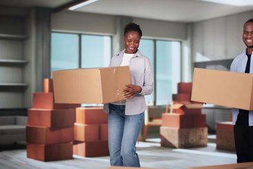 Happy Young Couple Moving Boxes