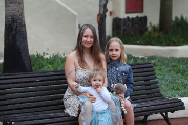 Family together. Smiling Mother and two daughter. Woman,...