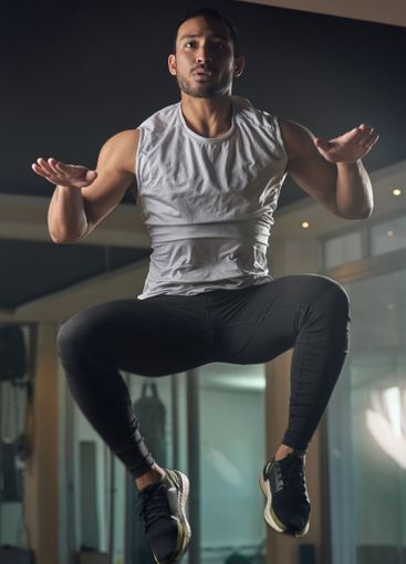 Workout, jumping and cardio with man in gym for...