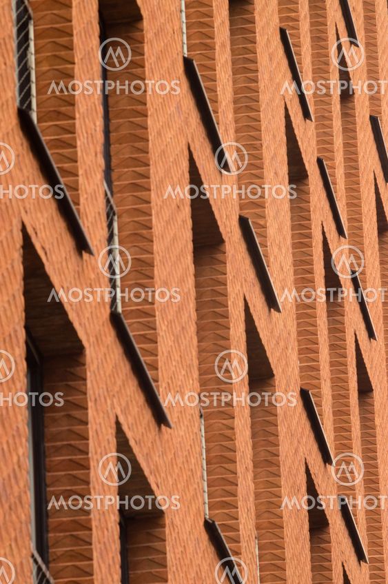 Orange brick wall with windows of modern building