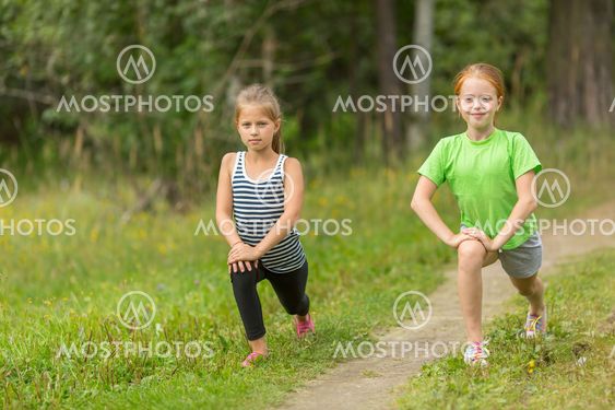 Two little girls warming up outdoors.