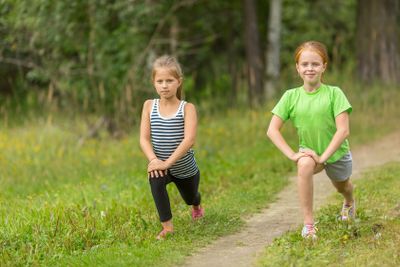 Two little girls warming up outdoors.