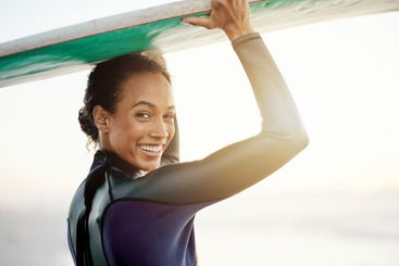 Smile, surfer or portrait of woman at sea for fitness...