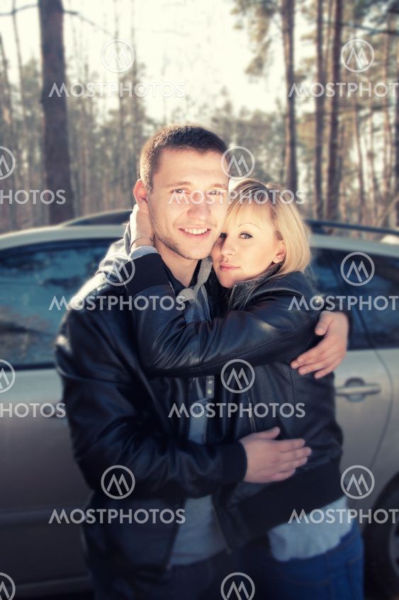 couple hugging outside in the forest