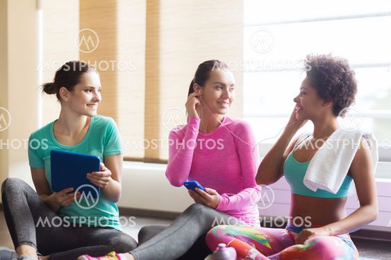 happy women listening to music in gym